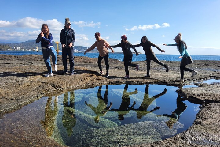 Experience the stunning coastal beauty of Jeju as you explore fascinating rock formations and serene waters creating unforgettable memories with friends along the breathtaking landscape.